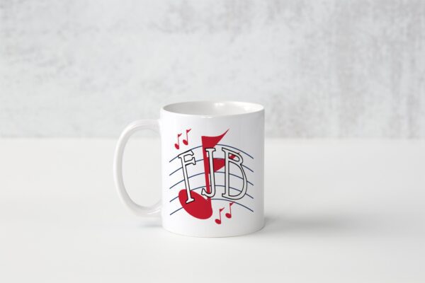 A white mug with red music notes on it.