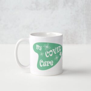 A white mug with the words " my covid cure ".