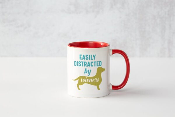 A red and white coffee mug with the words " easily distracted by animals ".