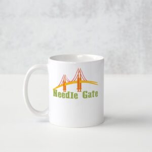 A white mug with the words needle gate on it.