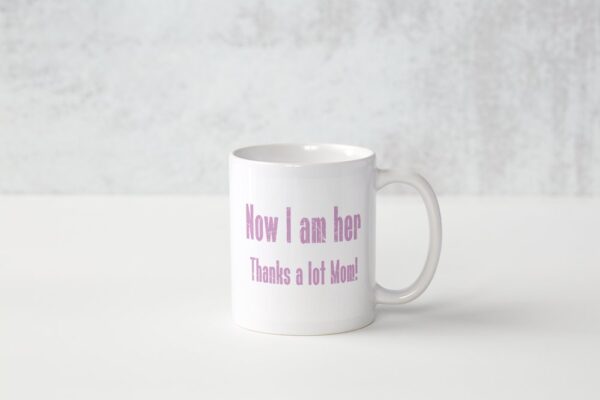 A white coffee mug with the words " now i am here, thanks a lot more !" printed on it.