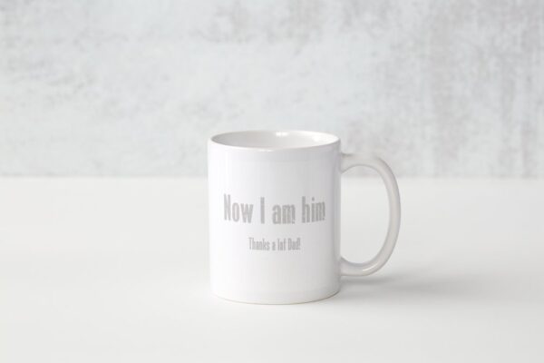A white coffee mug with the words " now i am him ".