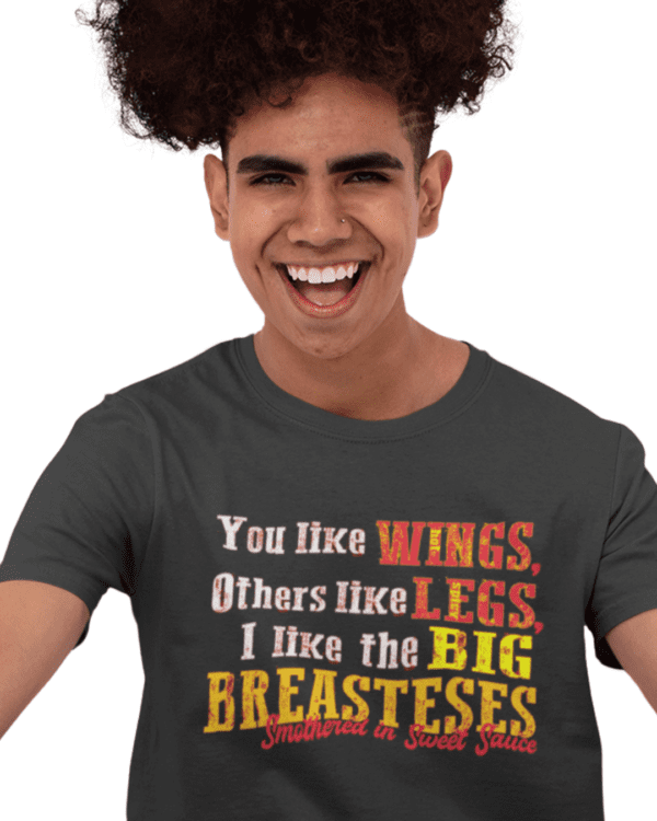 A man with curly hair and a t-shirt that says " you like wings, others like less, i like the big breastesses