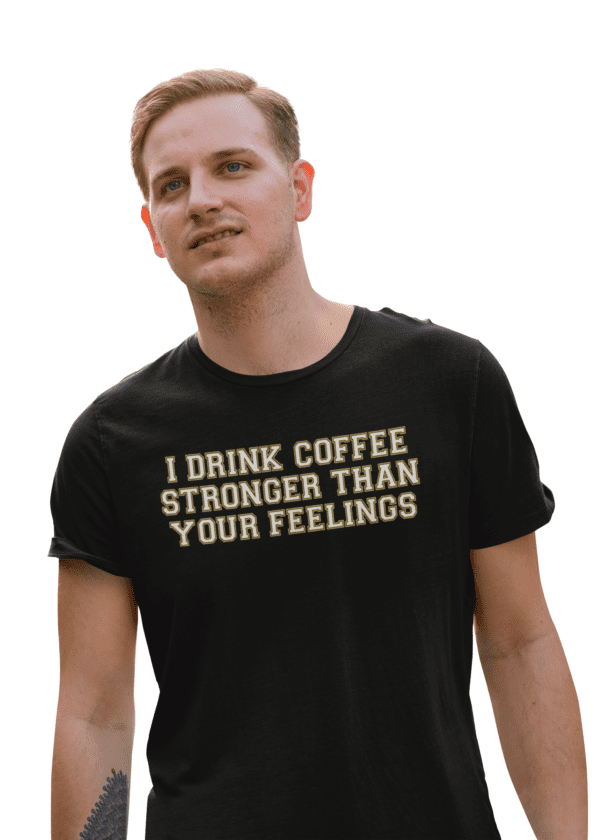 A man wearing a black shirt with the words " i drink coffee stronger than your feelings ".
