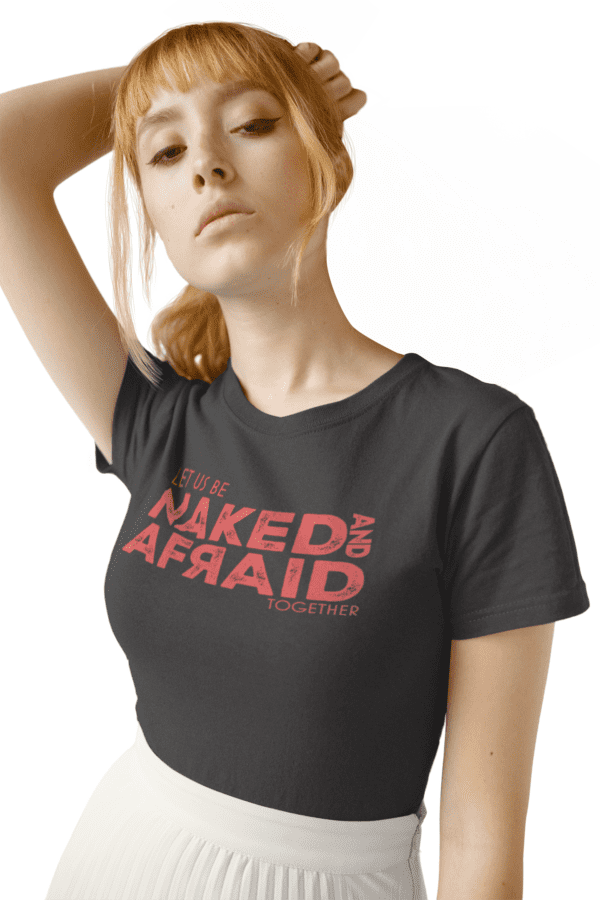 A woman wearing a black t-shirt with the words " naked and afraid " on it.